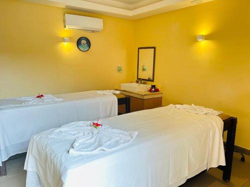 a room with two beds and a sink and a mirror at Hotel Marhaba Beach in Sousse