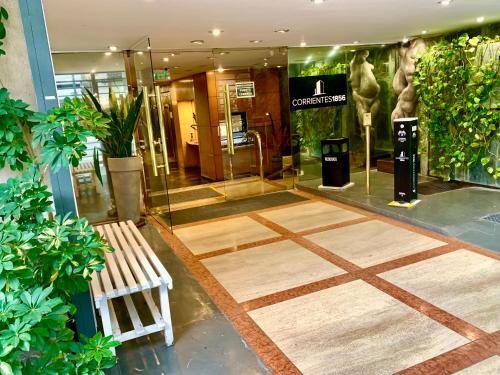 a lobby of a building with a bench and plants at Edificio Corrientes 1856 in Buenos Aires