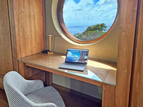 a laptop computer sitting on a desk with a window at Coulibri Ridge in Soufrière