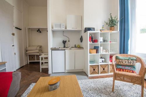 un salon avec une table et une cuisine dans l'établissement Le petit cosy, à Angers