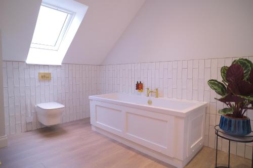 a white bathroom with a sink and a toilet at Lowwood Lodges in Houston