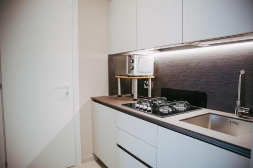 a kitchen with a sink and a stove at Olivia La Casa sul fiume in Terracina