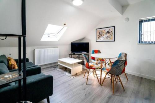 a living room with a couch and a table and chairs at 3 Bedroom Apartment, Walking Distance to Centre & Amazing Food at your door step in Cardiff