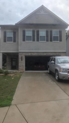 a car parked in front of a house with a garage at Sheray Spencer in Hampton