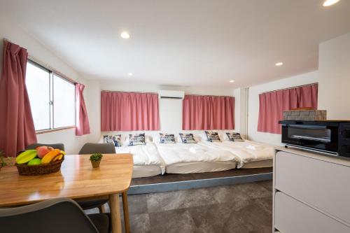 a bedroom with a large bed with red curtains at Hanarai Asakusa in Tokyo