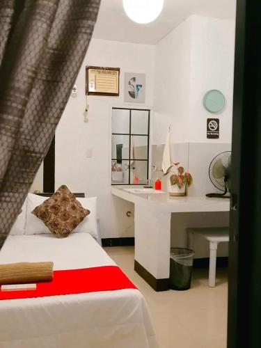 a bedroom with a bed and a desk in it at Julia's Family Hotel & Events Place - DANGCAGAN, BUKIDNON , PHILIPPINES in Dancagan