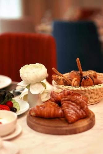 a table with a plate of food and a basket of food at Gewan Palace New Alamein in El Alamein
