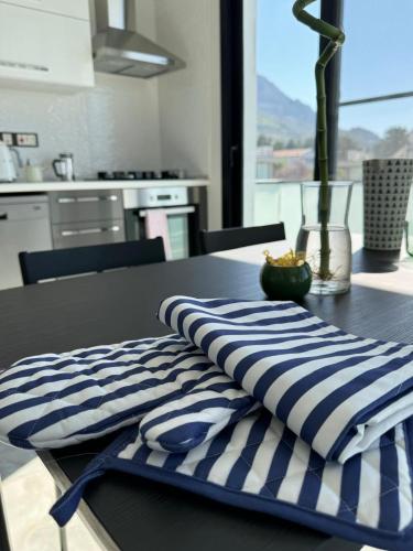 a table with blue and white striped towels on it at Penthouse in Lapta, a Cozy Coastal Retreat in Lapithos