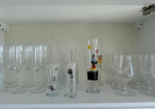 a row of clear wine glasses sitting on a counter at Penthouse in Lapta, a Cozy Coastal Retreat in Lapithos