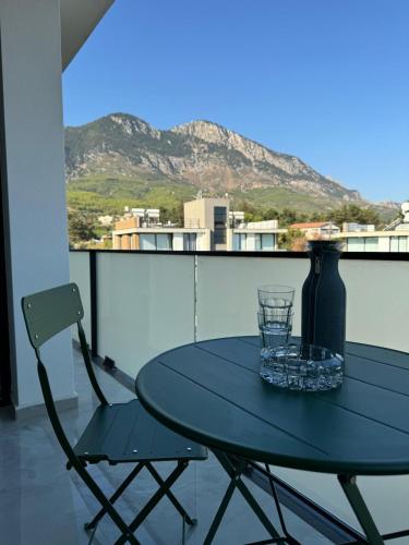 a blue table and chair on a balcony with a view at Penthouse in Lapta, a Cozy Coastal Retreat in Lapithos