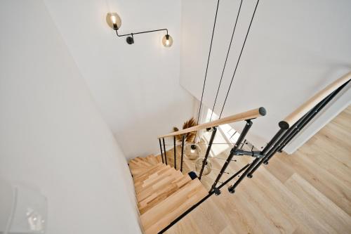 a spiral staircase in a house with wooden floors at Casa Baia BlueApart Hel in Hel