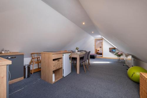 a kitchen and dining room with a table and chairs at Apartman u babky in Pavčina Lehota