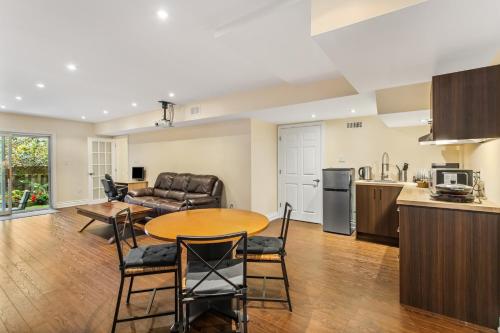 a kitchen and living room with a table and chairs at Cozy 1-BR, with Private Patio in Vaughan