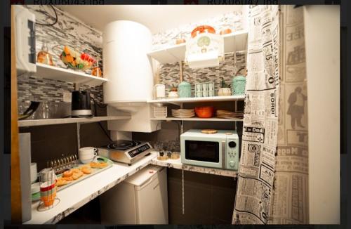 a small kitchen with a microwave on a counter at Bliss ' n joys in Montauroux