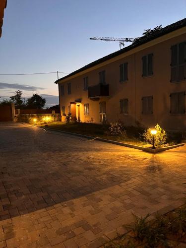 a building with lights on the side of it at night at Vin dell'Olmo in Castagnole Lanze