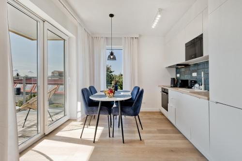 a kitchen and dining room with a table and chairs at Casa Baia BlueApart Hel in Hel