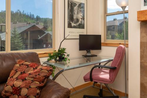 a room with a desk with a computer and a chair at Trailhead Lodges 821 in Winter Park