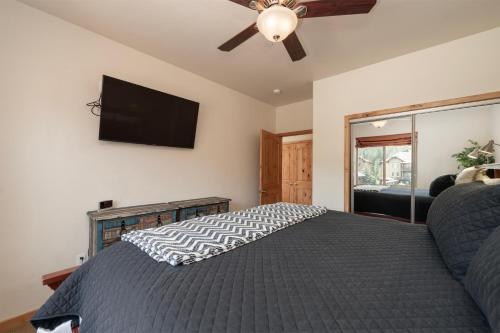 a bedroom with a bed and a flat screen tv at Trailhead Lodges 821 in Winter Park