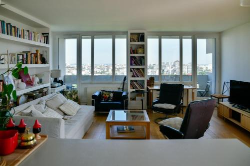 a living room with a couch and a table at Duplex rooftop vue Tour Eiffel in Bagnolet