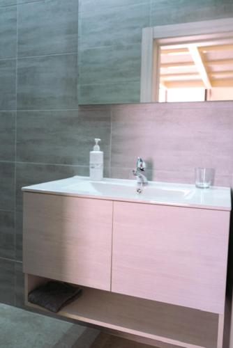 a bathroom with a sink and a mirror at La Chicca in Grottaglie