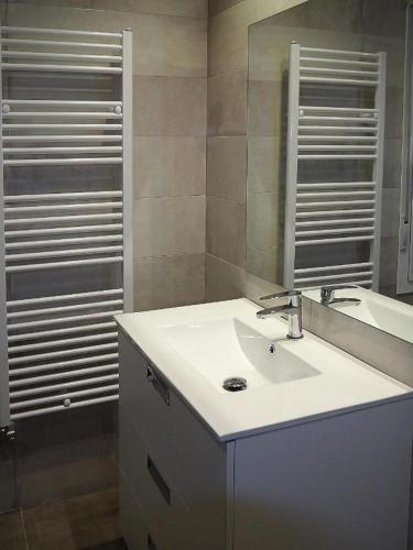 a bathroom with a white sink and a mirror at Casa Uva Republica Argentina 11 Logroño in Logroño