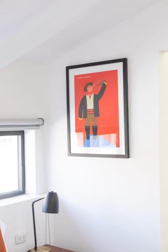 a framed picture of a man on a wall at Solara Art Hotel by Amak in Cusco