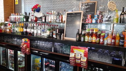 a bar with a lot of different types of drinks at Osterley Park Group Ltd Osterley Park Hotel in Isleworth