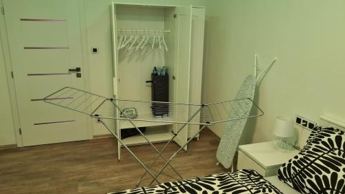 a room with a glass table and a closet at Apartmán Sokolovská in Karlovy Vary