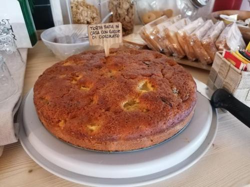 a cake sitting on a plate on a table at B&B Sass de Mura in Fiera di Primiero