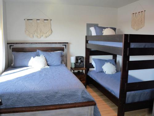 a bedroom with two beds and a bunk bed at Hot Tub & Panoramic Views Bear Butte &Buffalo Chip in Sturgis