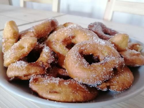 a pile of donuts on a plate on a table at B&B Sass de Mura in Fiera di Primiero