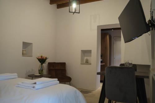 a bedroom with a bed and a table and a chair at AROMA DRYOS in Kato Drys