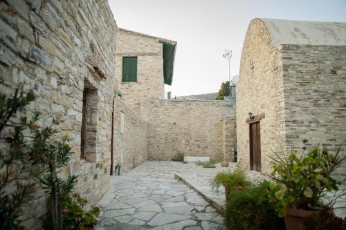 an alley in an old stone building at AROMA DRYOS in Kato Drys