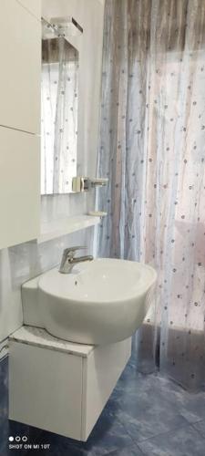 a bathroom with a white sink and a mirror at The Place - Splendido bilocale in centro con box auto in Civitanova Marche