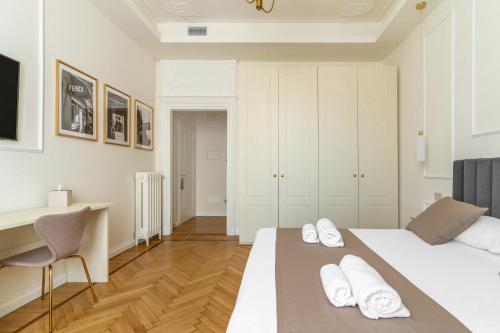 a bedroom with two beds and a desk in it at Montello Suites Foresteria Lombarda in Milan
