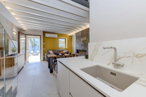 a kitchen with a sink and a counter top at Villa Beatrice front lake in Rocca dʼAnfo