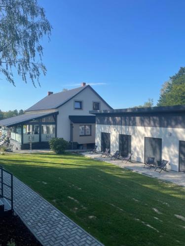 a large white house with a lawn in front of it at NH resort in Frýdek-Místek