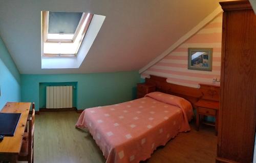 a bedroom with a bed and a desk and a window at Hotel Capellan in Navia