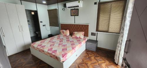 a bedroom with a bed with a comforter at Skyview Villa Udaipur with private pool 4Bhk Villa in Udaipur