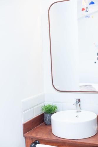 a bathroom with a white sink and a mirror at Solara Art Hotel by Amak in Cusco