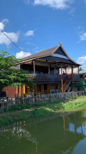 a building next to a body of water at NASRUL HOUSE HOMESTAY FOR BACKPACKERS in Maros