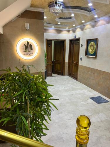 a lobby of a building with a potted plant at Noordana Apartments in Baghdad