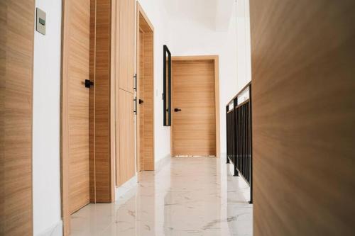 a hallway with wooden doors and marble floors at Villa luxury Kerry Residence 02 in Punta Cana