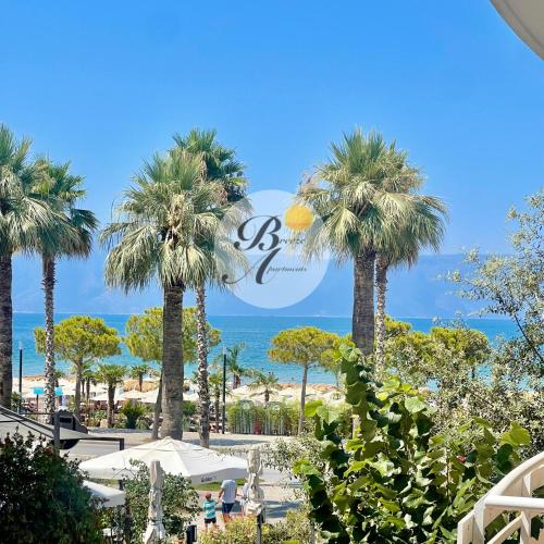 a view of a beach with palm trees and the ocean at Breeze Home in Vlorë