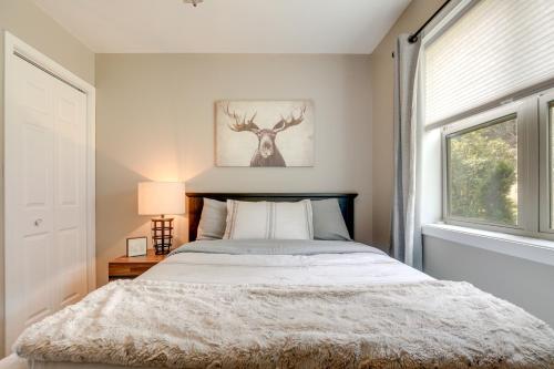 a bedroom with a bed and a window at Tranquil Lakefront Cabin Fire Pit, Grill and Patio in Tomahawk