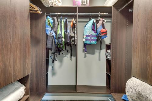 a walk in closet filled with lots of clothes at Tranquil Lakefront Cabin Fire Pit, Grill and Patio in Tomahawk