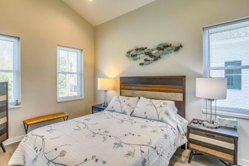 a bedroom with a bed and two windows at Carolina Beach Vacation Home Near Boardwalk in Carolina Beach