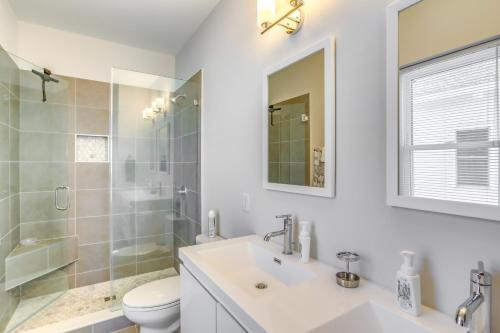 a bathroom with a sink and a toilet and a mirror at Carolina Beach Vacation Home Near Boardwalk in Carolina Beach
