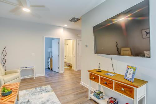 a living room with a large flat screen tv on the wall at Carolina Beach Vacation Home Near Boardwalk in Carolina Beach
