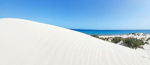 a large mound of snow with the ocean in the background at Follow The Sun-Camera con terrazza fronte mare in Portoscuso